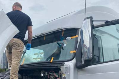 One of our technicians performing mobile window replacement service on a client's car oon site in Newark, DE